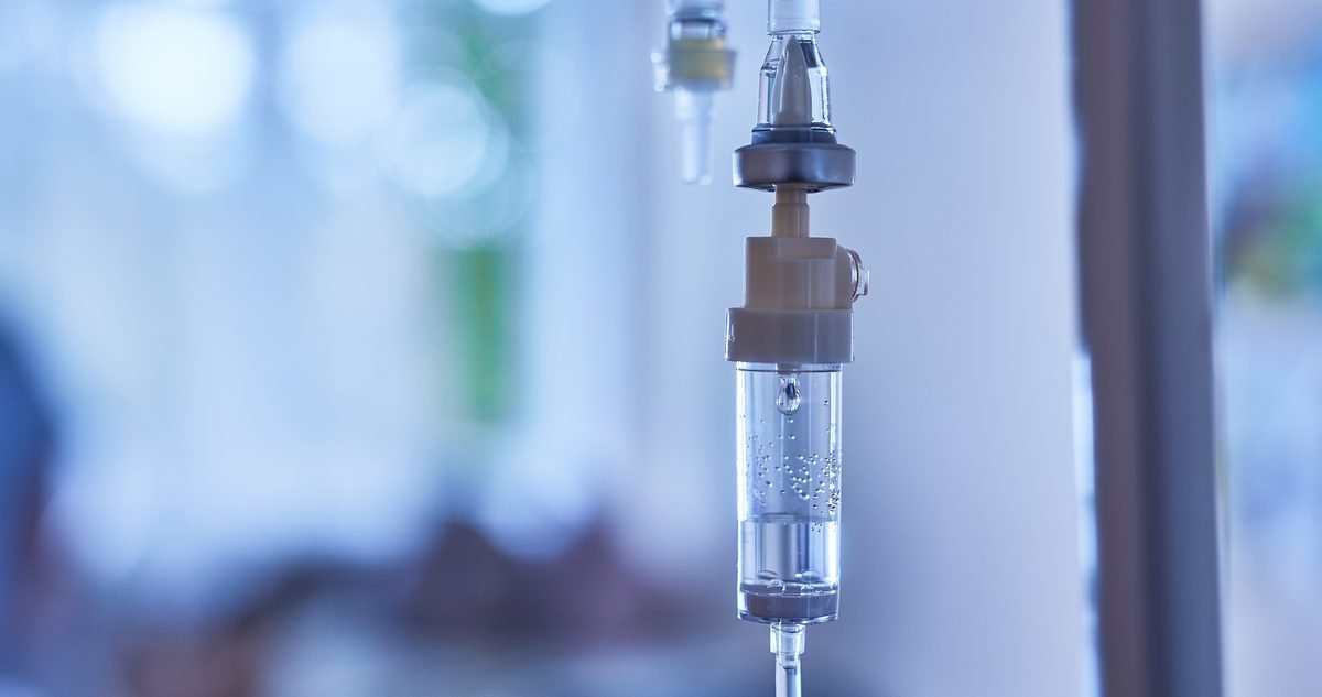 Intravenous fluid bag and line prepared for a patient being treated for dehydration in a clinical setting