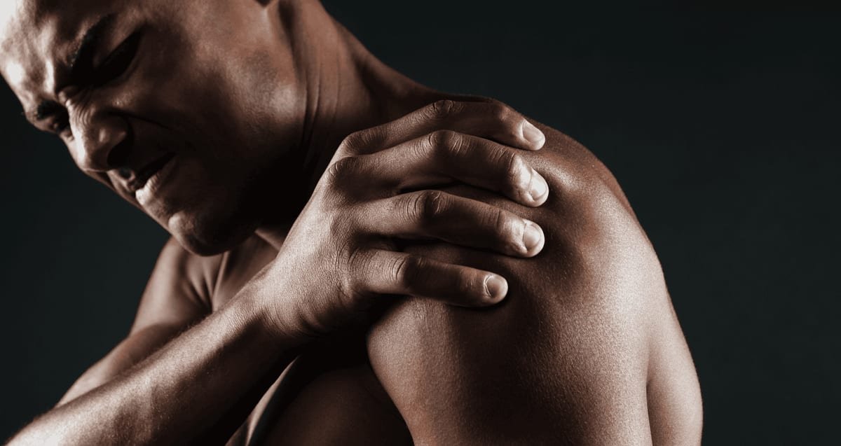 PRP for Rotator Cuff Tears: When Regenerative Medicine Is an Alternative to Surgery Man grimacing while gripping his painful shoulder, a sign of a rotator cuff injury treated with PRP therapy at Tyrance Orthopedics in Delray Beach.