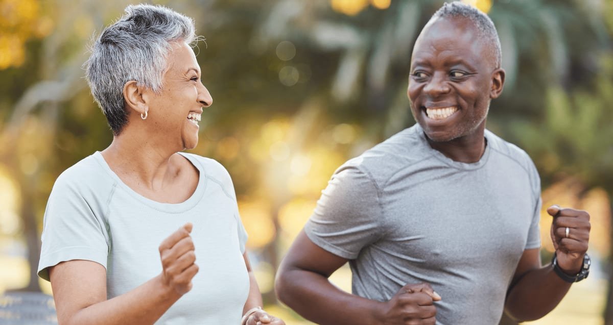 PRP Therapy for Boca Raton Patients at Tyrance Orthopedics Active older couple jogging outdoors and smiling, representing Boca Raton patients staying active with PRP regenerative therapy at Tyrance Orthopedics.