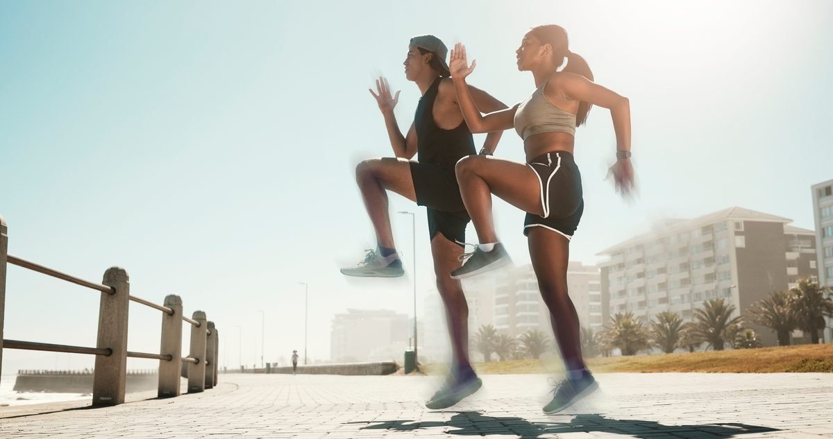 ACL Reconstruction Recovery Two runners mid-stride in an outdoor plyometric drill, the kind of loading a reconstructed knee has to handle before a return to sport.