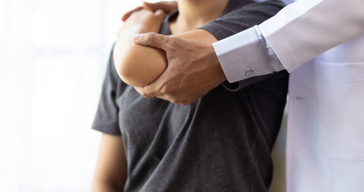 Rotator Cuff Surgery Recovery Clinician guiding a patient's arm through a range-of-motion check, the supervised work that follows rotator cuff surgery.